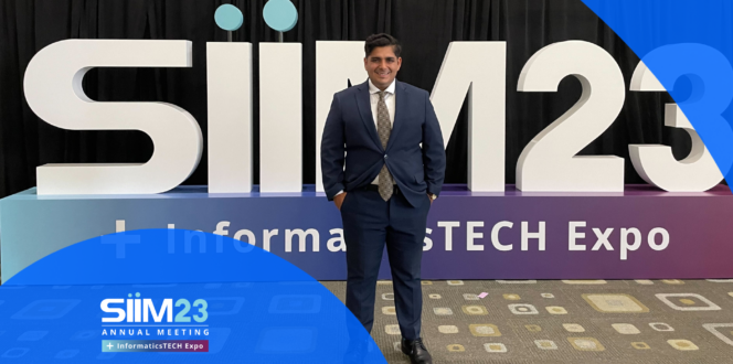 PocketHealth CEO Rishi Nayyar Standing in Front of 2023 SIIM Conference Sign