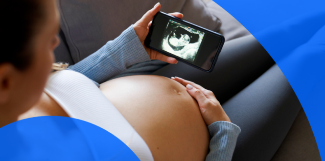 A pregnant patient looking at an ultrasound image on the phone